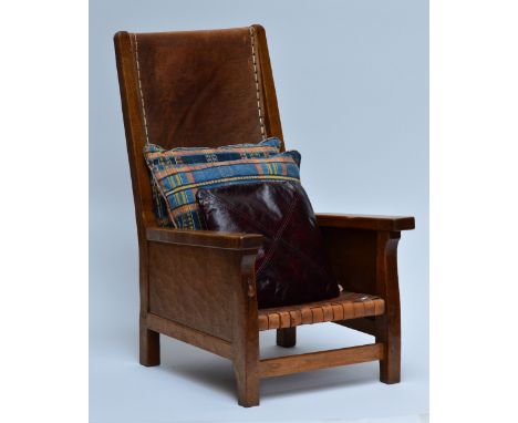 ROBERT 'MOUSEMAN' THOMPSON; an oak and leather smoker's armchair with raised back, strapwork seat and square sectioned legs u