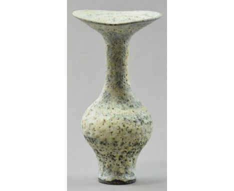 LUCIE RIE (1902-1995); a tall stoneware bottle, flared undulating rim and ovalled neck, eruptive glaze with bluish tones, imp