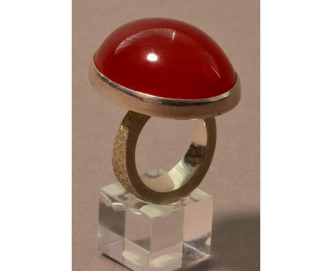 ROBERT FEATHER (born 1951); a hallmarked silver ring with large amber stone, ring size R.

Provenance: Commissioned and purch