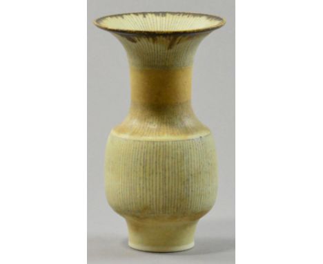 LUCIE RIE (1902-1995); a porcelain squat vase, creamy glaze with variegated colours, vertical and radiating inlaid lines, dar