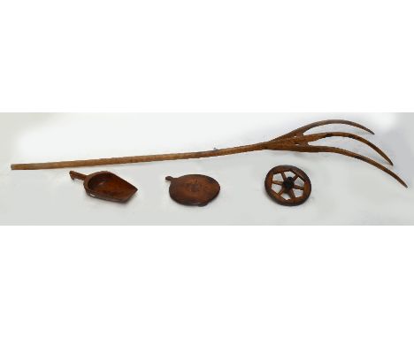A pitch fork, an elm grain scoop, a beech and iron clad wheel, and circular treen stand (4).
