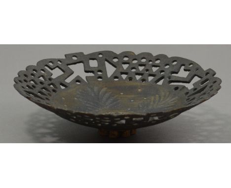 IAN GODFREY (1942-1992); a pierced stoneware footed dish, bronze glaze, incised floral decoration, diameter 18cm.

Provenance
