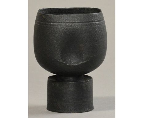 HANS COPER (1920-1981); a small stoneware flower holder, squared and pinched cup on drum base, burnished black slip, impresse