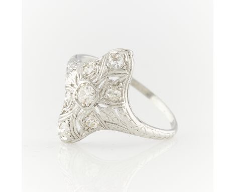 Platinum art deco style diamond ring, navette shaped, in filigree setting. One central old European cut diamond with six smal