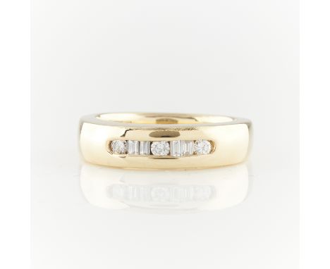 14k yellow gold ring channel set with three brilliant cut diamonds and four step cut diamonds in an alternating pattern. Unma