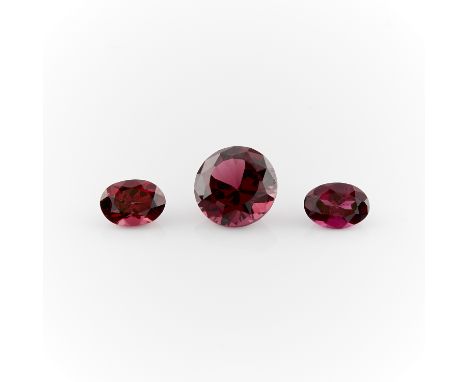 Group of rhodolite garnet loose stones, including one 3.55 ct round cut, and two oval cuts. One round cut weighing 3.55 ct. T