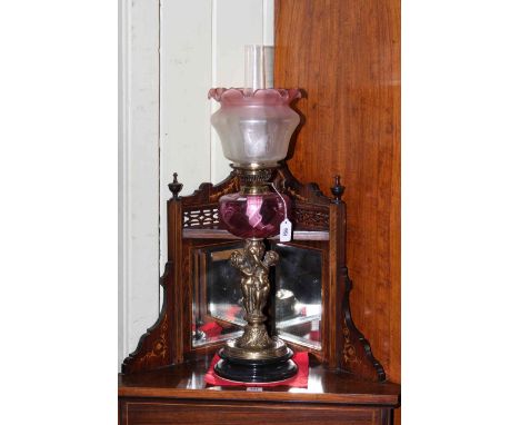 Brass cherub oil lamp with ruby glass reservoir