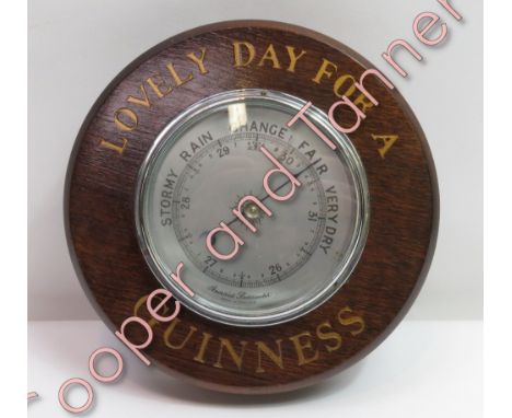 An oak cased wall barometer with gilt painted lettering 'Lovely day for a Guinness'