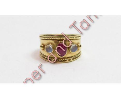 An 18 carat gold three stone ruby and moonstone dress ring, finger size R, 14.5 g gross