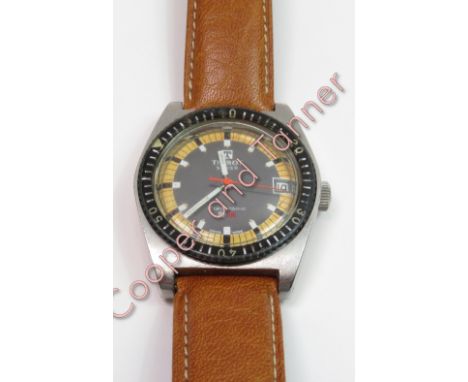 A Tissot Swiss pr516 diver's wrist watch with a leather strap and an orange dial