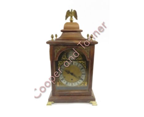 A walnut cased mantel clock, the silvered dial having Tempus Fugit to the arch, raised on bracelet feet, 57cm high