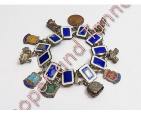 A bracelet of enamel panels, stamped 'Silver', with charms attached, 37.9 g gross