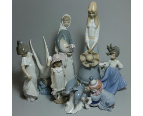 A Lladro figure of a lady with a lamp impressed mark 4582, another of a clown with a puppy , 5278, three NAO figures and two 