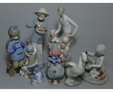 A Lladro figure of a clown with balloons impressed mark 5811, another of a boy with a polar bear, three NAO figures and three