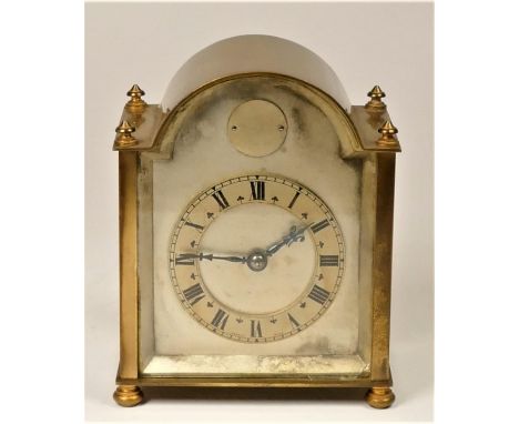 An arched brass manual wind carriage clock, striking with Roman numeral dial, 15 x 12 cm