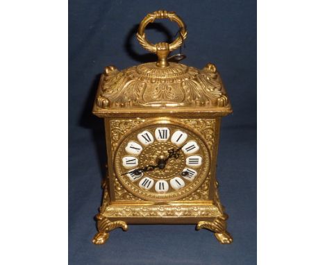 Elaborate brass mantel clock with enamel numerals and striking movement