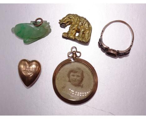 A small carved jade pendant, 24mm long, 3.5g, a Georgian ring set paste, (centre stone missing) and other items. 