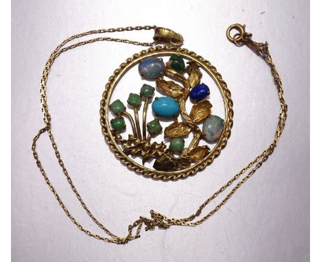 A yellow metal circular pendant with flowers and leaves set jade, opals, turquoise and lapis lazuli, on chain. 