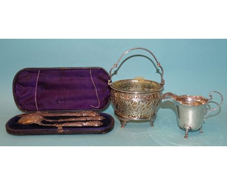 A silver swing-handled sugar bowl with pierced floral panels, raised on four tab feet, (glass liner broken and glued), maker 