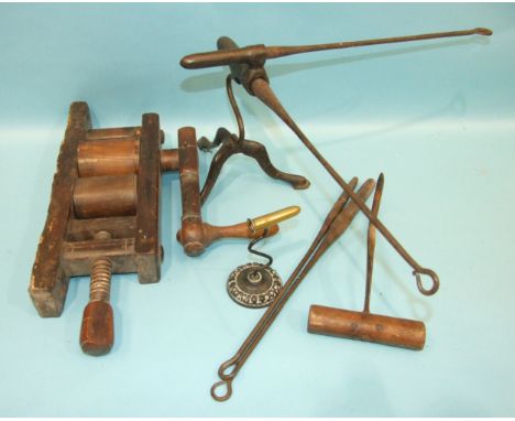 A Victorian tripod poker iron stand, 25cm high, (tripod damaged), a smaller iron and brass iron holder, four pokers of variou