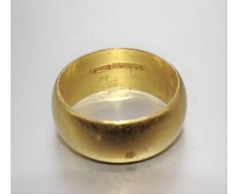 A 22ct gold wedding ring, 7mm wide, size K½, 7.9g. 