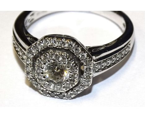 A diamond halo cluster ring set a brilliant-cut diamond of approximately 0.2cts, within two concentric octagonal borders of b