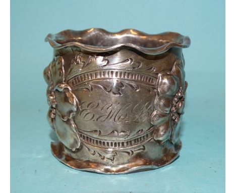 An early-20th century American sterling silver napkin ring by George W Shiebler &amp; Co, cast with floral decoration and wav