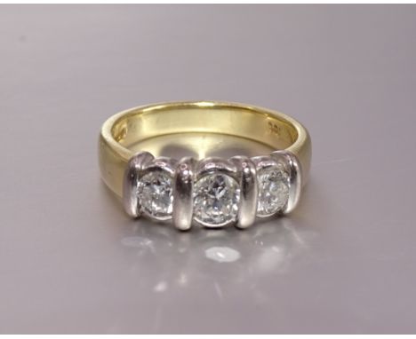 A three-stone diamond ring channel-set three brilliant-cut diamonds, SI-P, I-J, estimated total weight 0.98cts, in 18ct yello