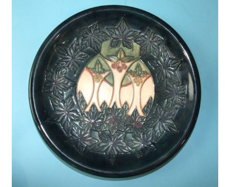 A Moorcroft circular plate with 'Cluny' tubelined decoration, 26cm diameter, impressed factory marks and blue WM initial to b