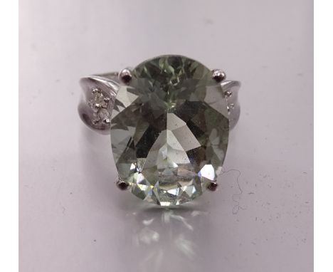 A 9ct white gold ring set orthoclase feldspar between diamond-set shoulders, size P, 5.1g. 