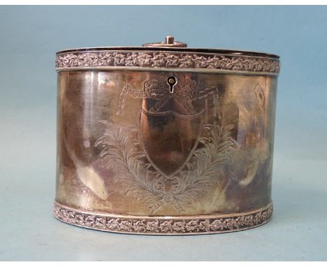 A silver tea caddy of oval form with engraved decoration, chased rims and hinged lid, E Baker &amp; Son, Birmingham 1902, ___