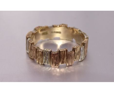 A tri-colour 9ct gold ring of textured abstract design, size P, 4.6g. 