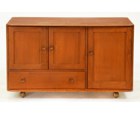 An Ercol fumed ash sideboard, with panelled doors, on castors, 71cm h; 114cm l  Top slightly marked