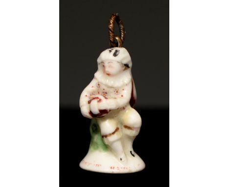 A St James porcelain seal, c1755, in the form of a seated musician in a ruff playing the hurdy-gurdy, the base inscribed in r
