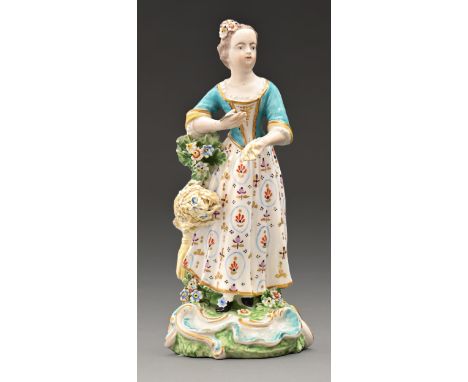 A Derby figure of a Chelsea Season, c1770, the young woman holding wheat and a bill hook in turquoise bodice and flowered ski