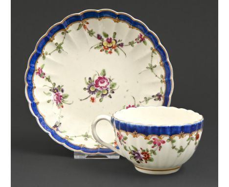 A Worcester fluted teacup and saucer, c1780, painted with bouquets and swags in blue and gilt border, saucer 13.5cm diam, pai