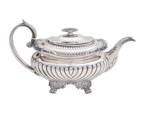 A George IV silver teapot,&nbsp;the gadrooned rim with shells at intervals, crested, handle with ivory insulators, 16cm h, by