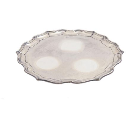 A George V silver salver, on three pad feet, 37cm diam, by Williams Adams Ltd, Birmingham 1933, 35ozs 8dwts  Light polish scr