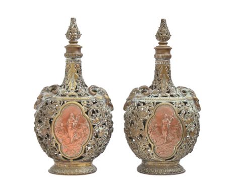 A pair of French cast brass openwork pilgrim bottles and stoppers, late 19th c, with ram's head shoulder-handles, each side a