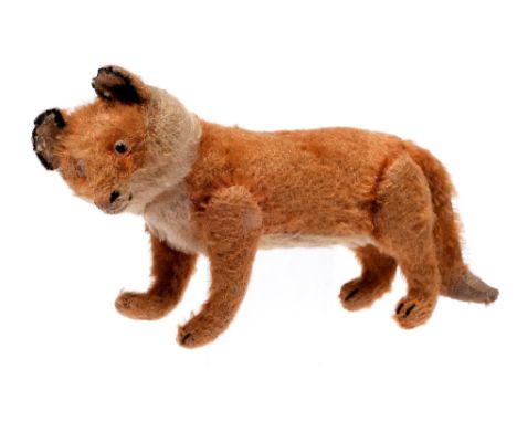German soft toy. A Steiff fox, circa early 20th c, with glass eyes, moveable head and legs, 21cm l, Steiff metal button to le