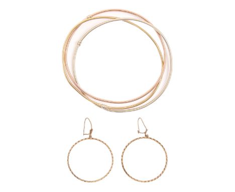 A 9ct three colour gold triple bangle, 70mm, import marked Birmingham 1994 and a pair of 9ct gold hoop earrings, 8.3g (3)  Go