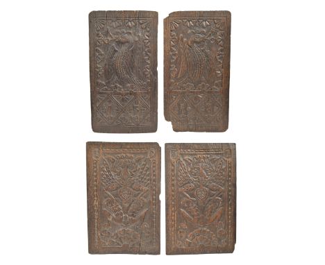 Two pairs of 16th c oak panels, Northern European, dated 1537 and 1558, carved with a winged male grotesque or a plumed bird,