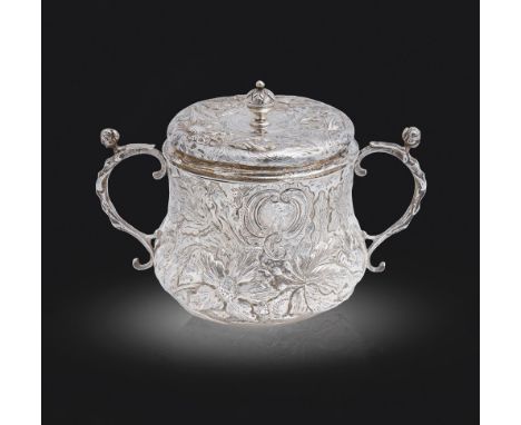 A Charles II silver porringer and cover,&nbsp;decorated in punchwork and chased in high relief with flowers and foliage aroun
