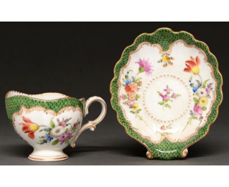 A German porcelain shell shaped scale green ground cabinet cup and saucer, early 20th c,&nbsp; painted with flowers, saucer 1