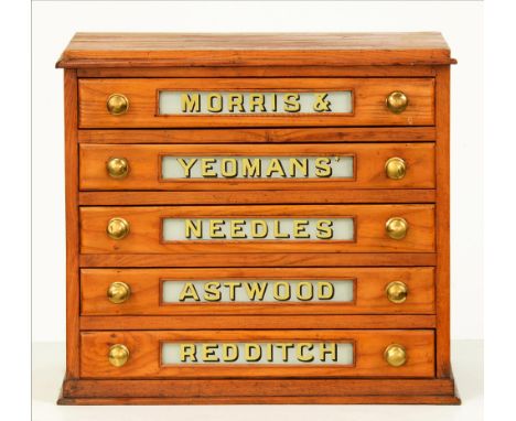 Shop fittings. An English oak and sycamore haberdashery shopkeeper's bobbin cabinet, the five graduated drawers each with ver