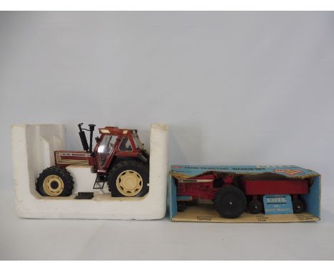 Two boxed Ertl die-cast tractors comprising the 18090 Turbo Fiat, and the International Tractor Wagon set. 
