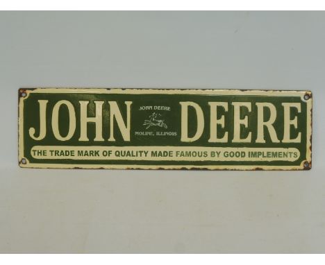 A reproduction John Deere enamel sign, 15 1/2 x 4 1/2". 