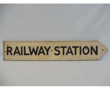 A cast aluminium 'Railway Station' single sided directional arrow sign, 38 x 7". 