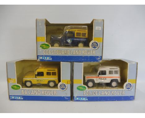 Three boxed Ertl 1:32 scale Land Rovers. 