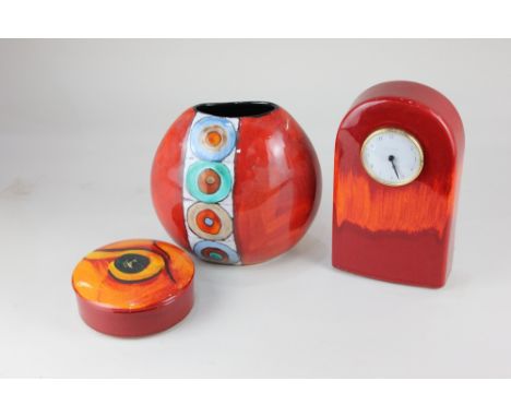 A Poole pottery vase, oviform, decorated with a vertical patterned band on red and orange ground, 20cm high, together with a 